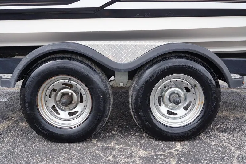 Slide: The Image of Trailer wheels of a 2018 Yamaha Boats 242 Limited S on pavement. - 4