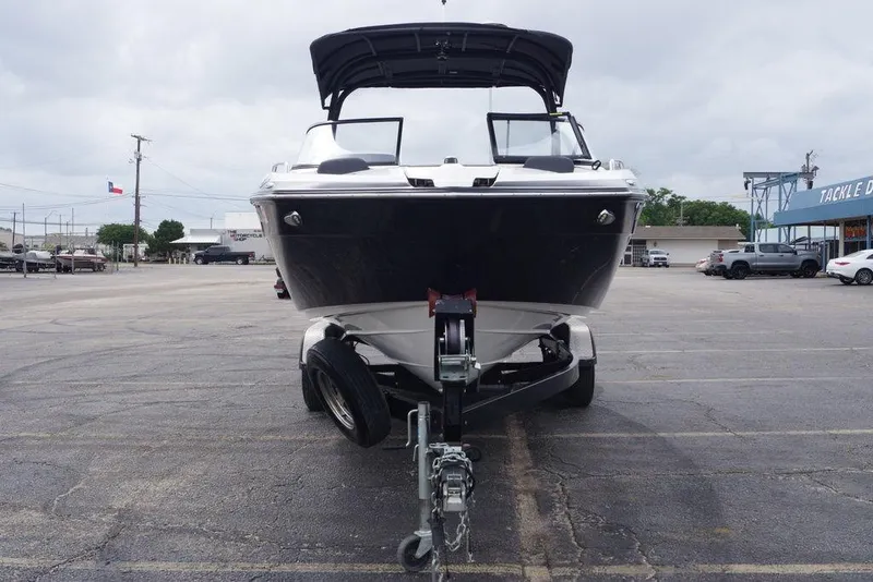 Slide: The Image of 2018 Yamaha Boats 242 Limited S on trailer in parking lot, overcast sky. - 5