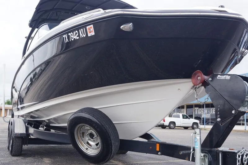 Slide: The Image of 2018 Yamaha Boats 242 Limited S on trailer, black and white hull. - 6