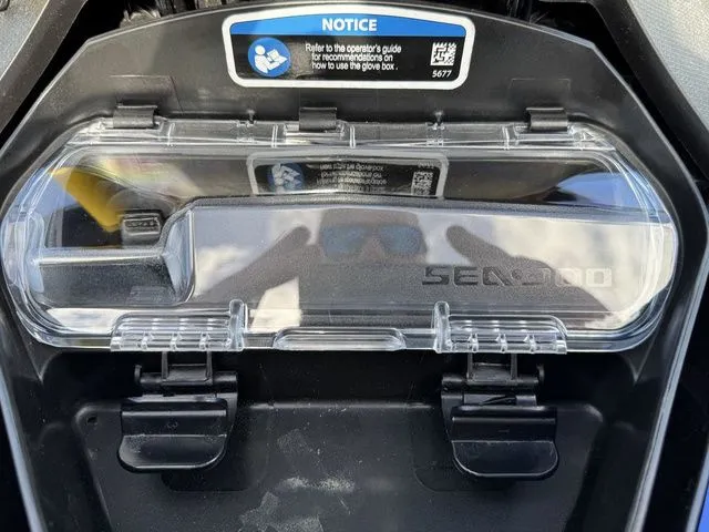 Slide: The Image of 2025 Sea-Doo Wake glove box with user guide notice. - 17