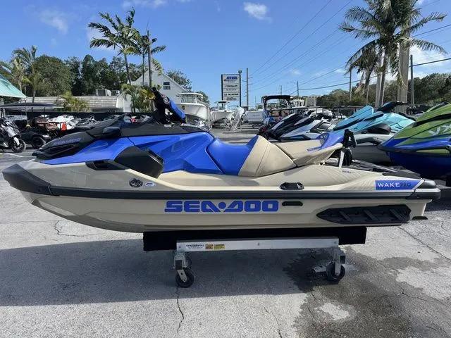 Slide: The Image of 2025 Sea-Doo Wake jet ski in blue and beige on a parking lot. - 5
