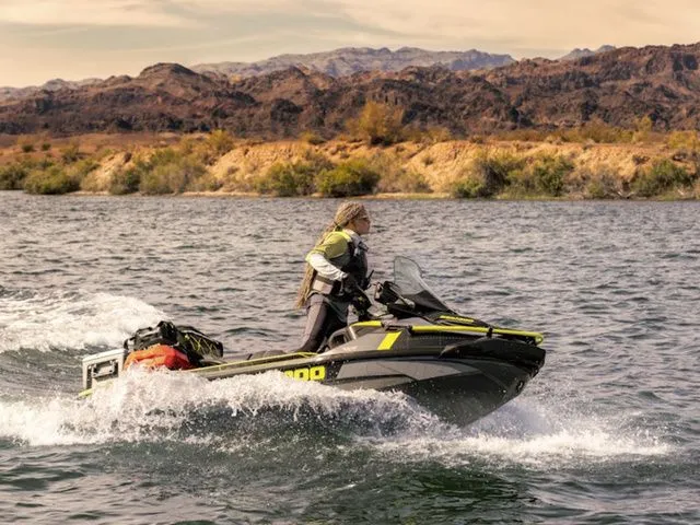 The Image of Woman riding 2026 Sea-Doo Explorer Pro on a lake. - 1