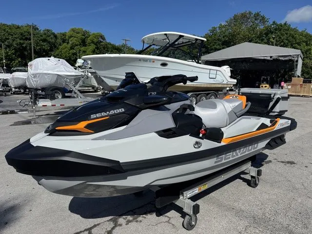 Slide: The Image of 2025 Sea-Doo FISH PRO jet ski on a trailer outdoors. - 5