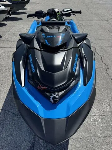 Slide: The Image of 2026 Sea-Doo RXT-X jet ski in blue and black on asphalt. - 3