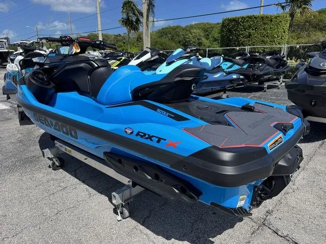 Slide: The Image of 2026 Sea-Doo RXT-X jet ski in blue on a parking lot. - 6