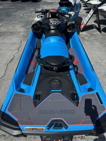 Slide: The Image of 2026 Sea-Doo RXT-X jet ski in vibrant blue on asphalt. - 7