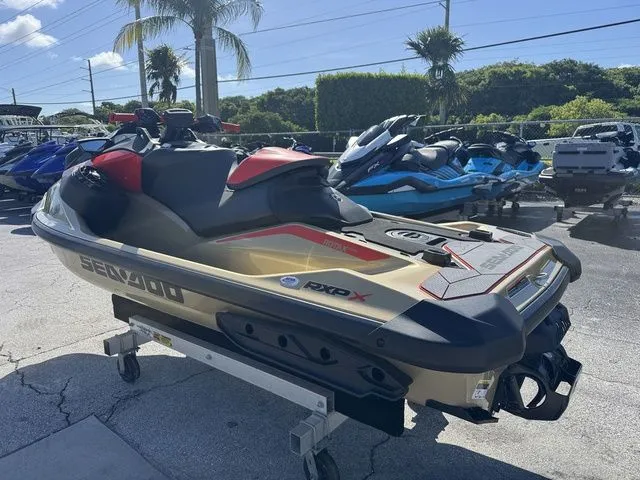 Slide: The Image of 2025 Sea-Doo RXP-X 325 jet ski in a parking lot. - 6