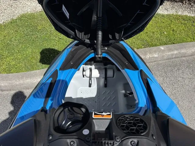 Slide: The Image of 2026 Sea-Doo RXP-X 325 Tech in Gulfstream Blue, open storage compartment. - 24