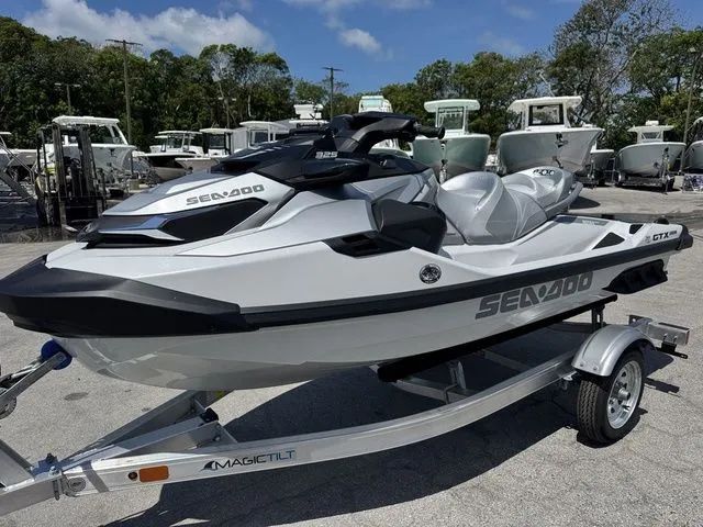 Slide: The Image of 2026 Sea-Doo GTX jet ski on trailer, parked outdoors. - 4