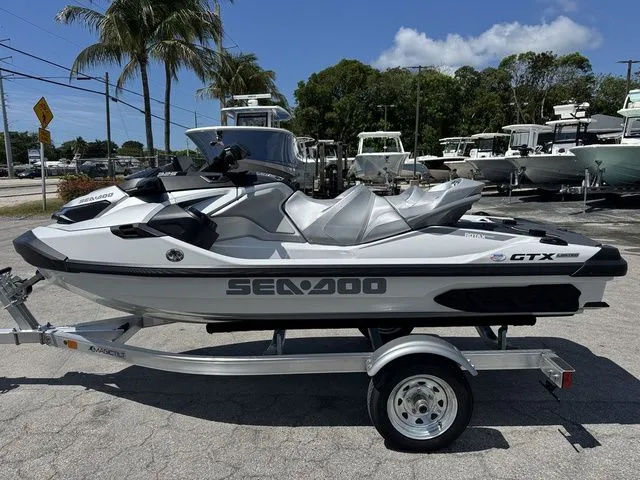Slide: The Image of 2026 Sea-Doo GTX jet ski on trailer, parked outdoors. - 5