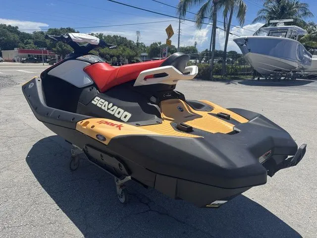Slide: The Image of 2025 Sea-Doo Spark for 3, black and yellow, parked outdoors. - 7