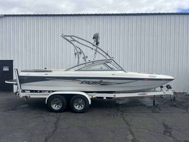 The Image of 2008 Tigé 22i boat on trailer in front of warehouse. - 1