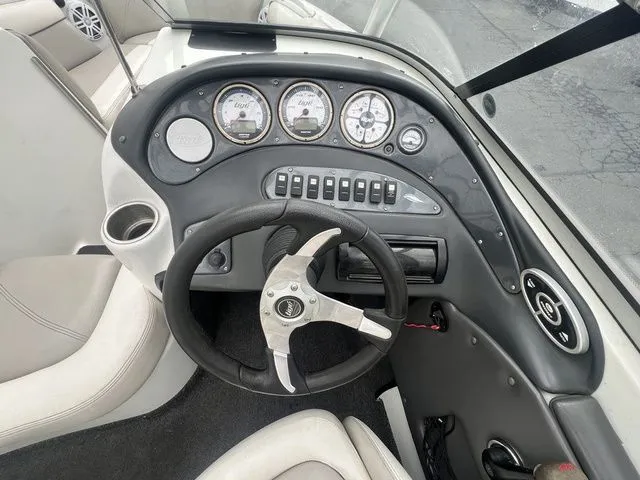 Slide: The Image of Dashboard of a 2008 Tigé 22i boat with steering wheel and gauges. - 15