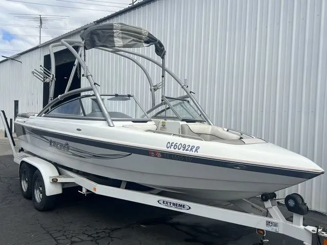 Slide: The Image of 2008 Tigé 22i boat on trailer outside warehouse. - 2