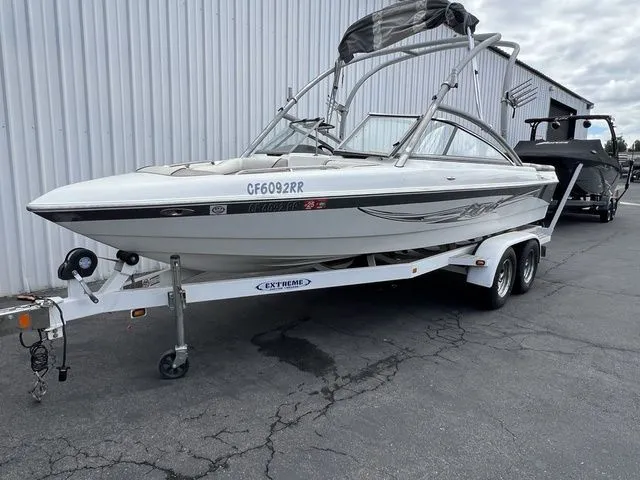 Slide: The Image of 2008 Tigé 22i boat on trailer outside warehouse. - 6