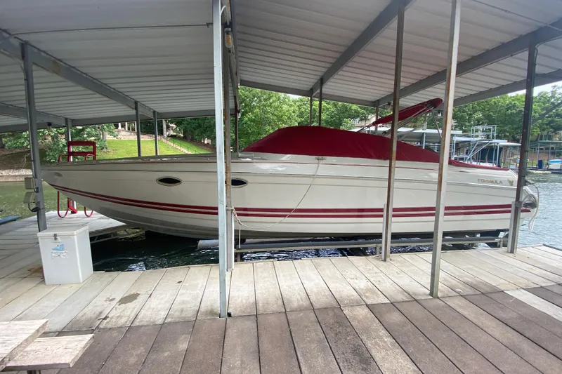 Slide: The Image of 2001 Formula 330 Sun Sport boat docked under a covered marina. - 52