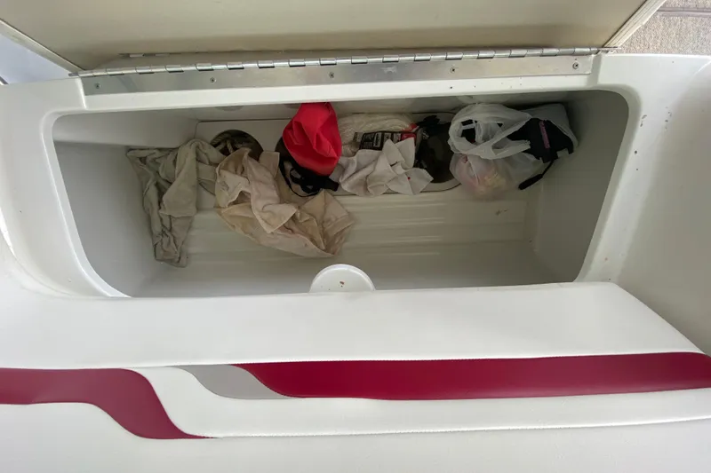 Slide: The Image of Storage compartment of a 2001 Formula 330 Sun Sport boat with various items inside. - 44