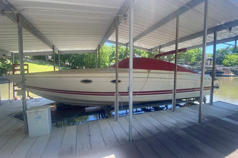 The Image of 2001 Formula 330 Sun Sport boat docked under a covered marina. - 1
