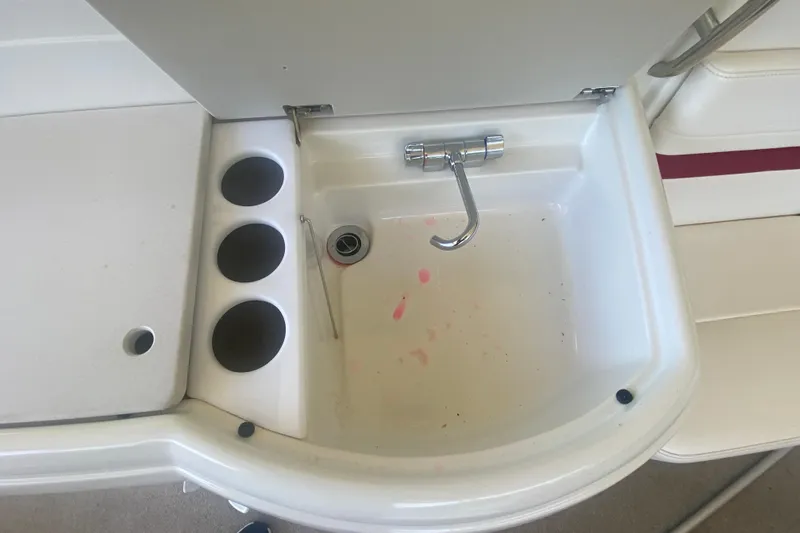 Slide: The Image of 2001 Formula 330 Sun Sport boat sink with faucet and cup holders. - 11