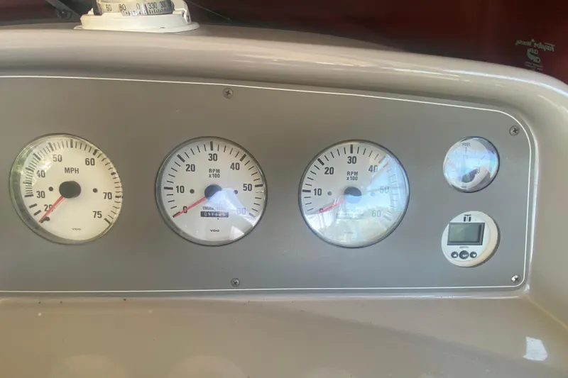 Slide: The Image of Dashboard of a 2001 Formula 330 Sun Sport boat with speedometer and RPM gauges. - 13