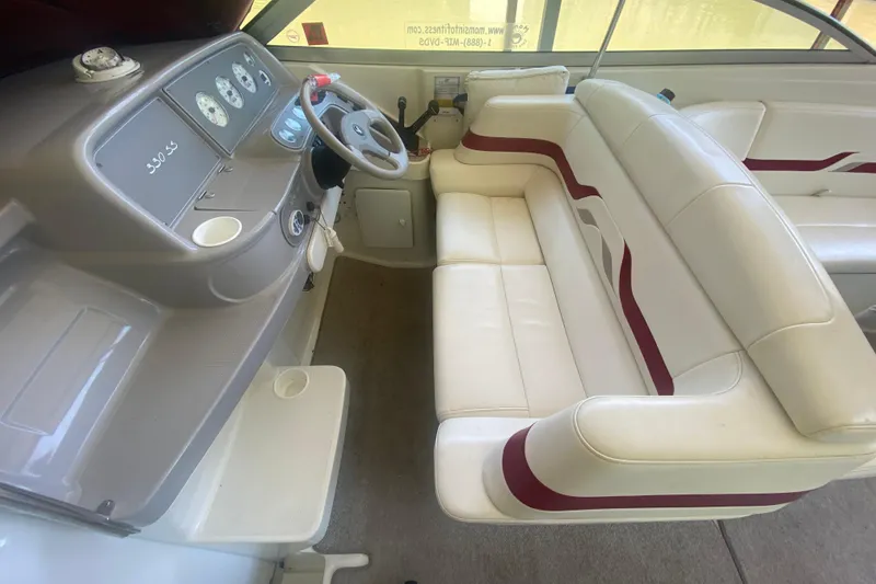 Slide: The Image of 2001 Formula 330 Sun Sport boat interior with white and red seating, dashboard, and steering wheel. - 16