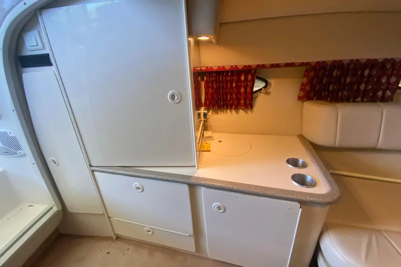 Slide: The Image of Interior of 2001 Formula 330 Sun Sport boat with kitchenette and seating area. - 24