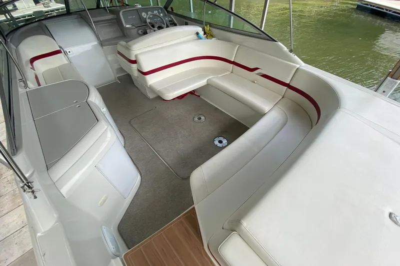 Slide: The Image of 2001 Formula 330 Sun Sport boat interior with white and red seating, docked by the water. - 39