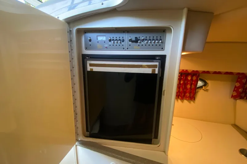 Slide: The Image of 2001 Formula 330 Sun Sport cabin with control panel and compact refrigerator. - 25