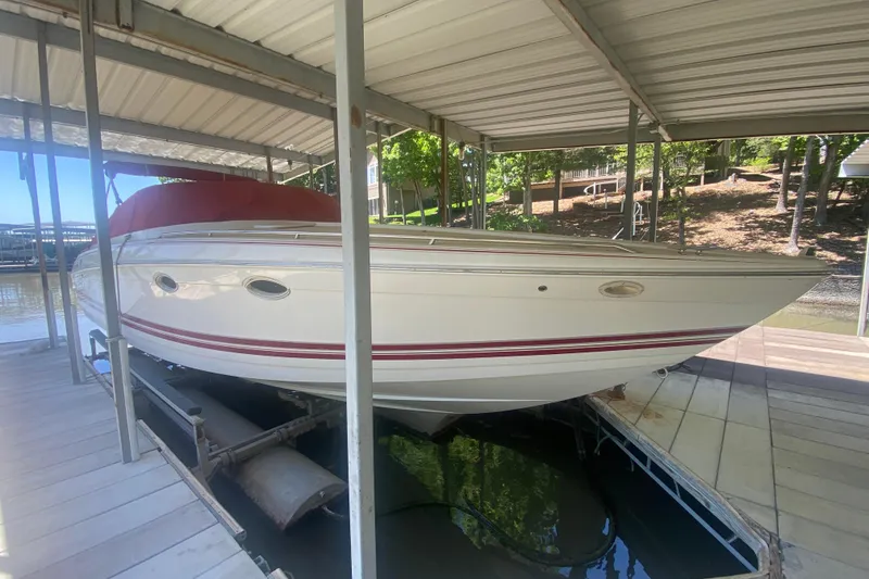 Slide: The Image of 2001 Formula 330 Sun Sport boat docked under a covered slip, featuring a sleek white design. - 3