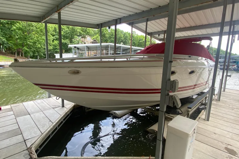 Slide: The Image of 2001 Formula 330 Sun Sport boat docked under a covered marina with red accents. - 54