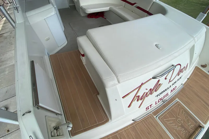 Slide: The Image of 2001 Formula 330 Sun Sport boat interior with cushioned seating and wooden flooring. - 38