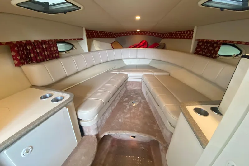 Slide: The Image of Interior of a 2001 Formula 330 Sun Sport boat with plush seating and cup holders. - 57
