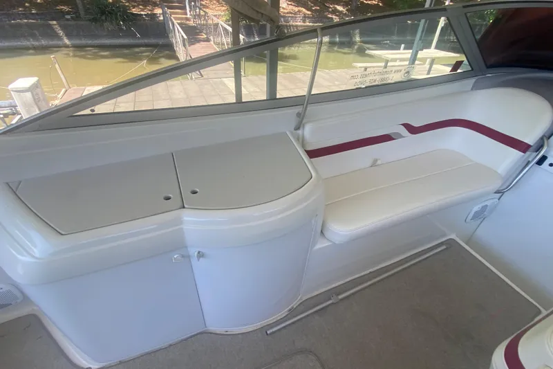 Slide: The Image of 2001 Formula 330 Sun Sport boat interior with white seating and storage area. - 9