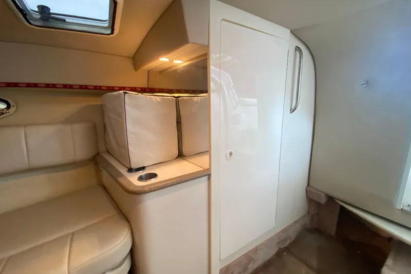 Slide: The Image of Interior cabin of a 2001 Formula 330 Sun Sport boat, featuring seating and storage. - 60