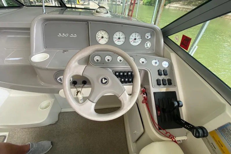 Slide: The Image of 2001 Formula 330 Sun Sport dashboard with steering wheel and control panel. - 46