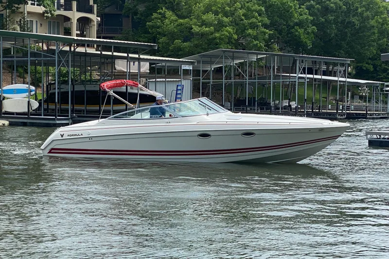 Slide: The Image of 2001 Formula 330 Sun Sport boat on water near docks and greenery. - 37