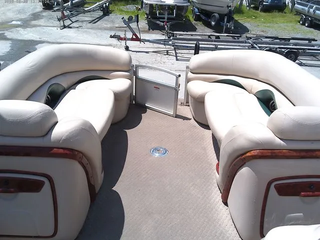 Slide: The Image of Interior of a 2010 Tracker Party Barge 22 with beige seating. - 12