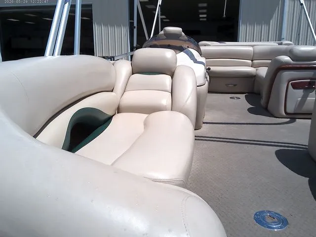 Slide: The Image of Interior of a 2010 Tracker Party Barge 22 pontoon boat with beige seating. - 5