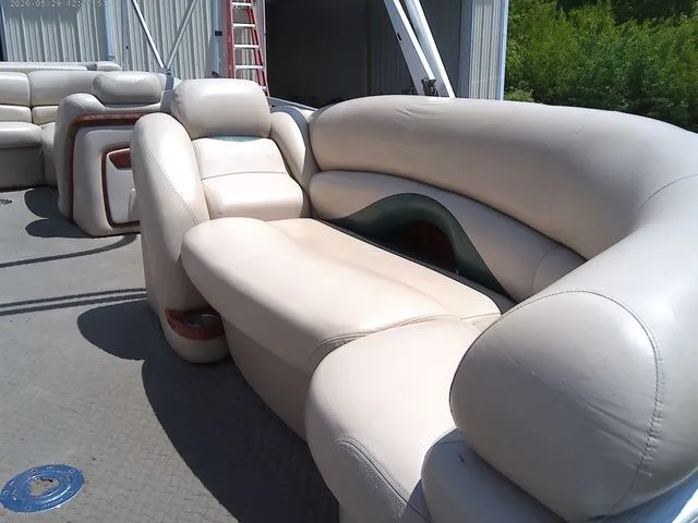 Slide: The Image of Interior of a 2010 Tracker Party Barge 22 with beige leather seating. - 6
