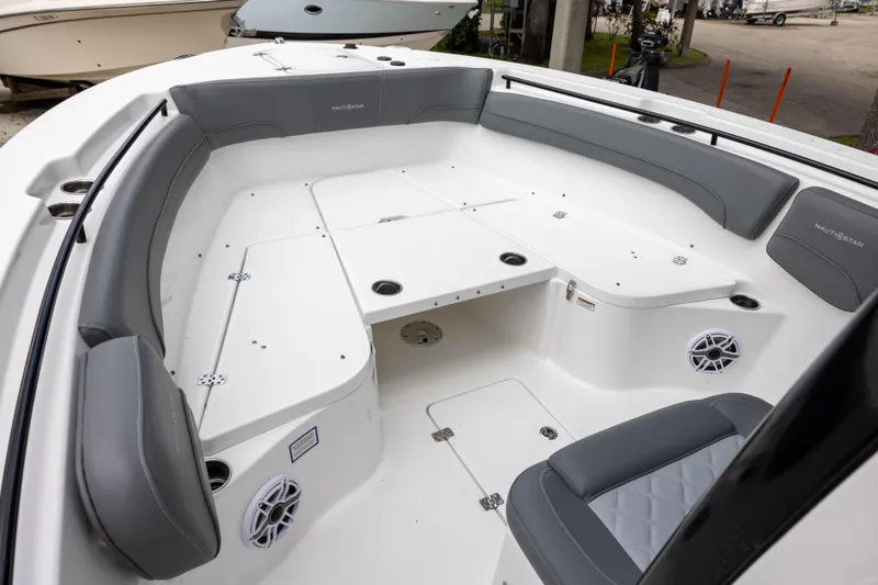 Slide: The Image of 2024 NauticStar 292 Legacy boat interior with gray seating and white deck. - 14