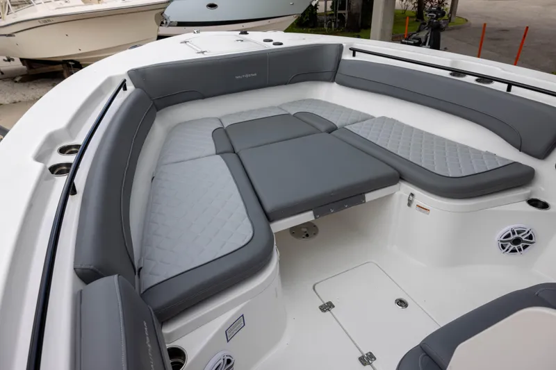 Slide: The Image of 2024 NauticStar 292 Legacy boat with luxurious gray seating and spacious deck layout. - 15
