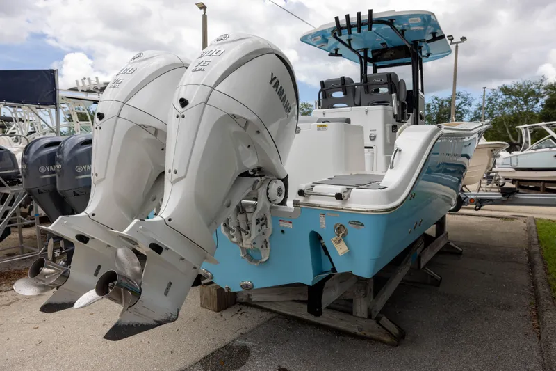 Slide: The Image of 2024 NauticStar 292 Legacy boat with dual Yamaha engines, displayed outdoors. - 3