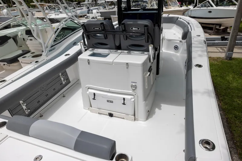 Slide: The Image of 2024 NauticStar 292 Legacy boat interior with seating and storage features. - 4