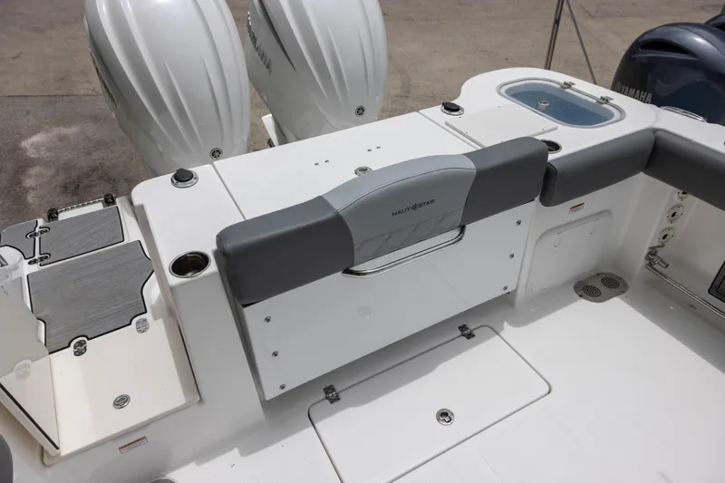 Slide: The Image of 2024 NauticStar 292 Legacy boat interior with dual engines and seating area. - 5