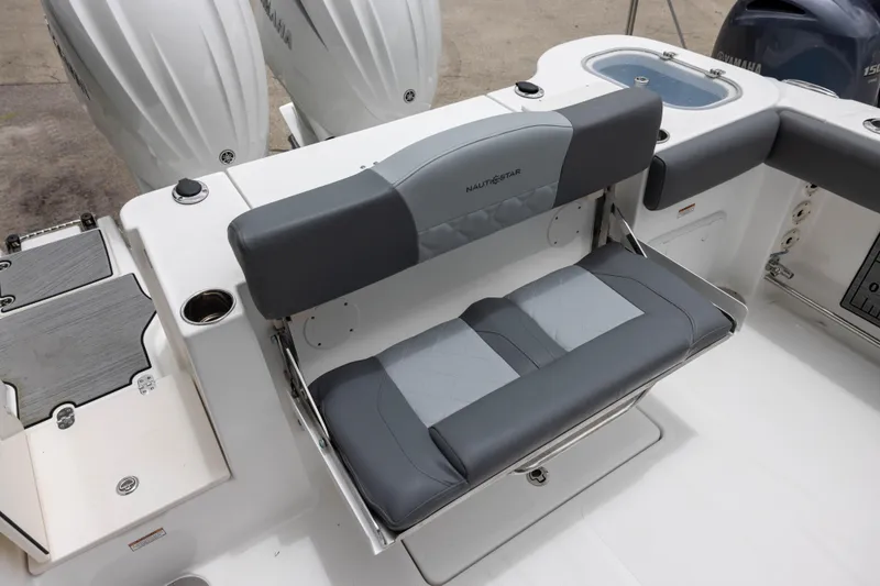 Slide: The Image of 2024 NauticStar 292 Legacy boat seating area with Yamaha engines in background. - 6