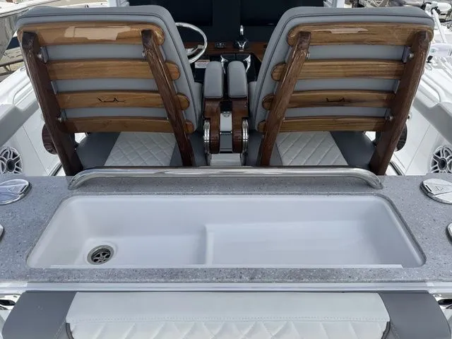 Slide: The Image of Interior of Everglades 315 Center Console 2026 with seating and sink. - 7