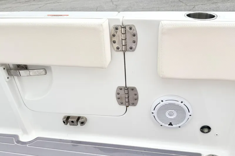 Slide: The Image of 2023 Sea Hunt Escape 28 boat interior with speaker, cup holder, and stainless steel hinges. - 10