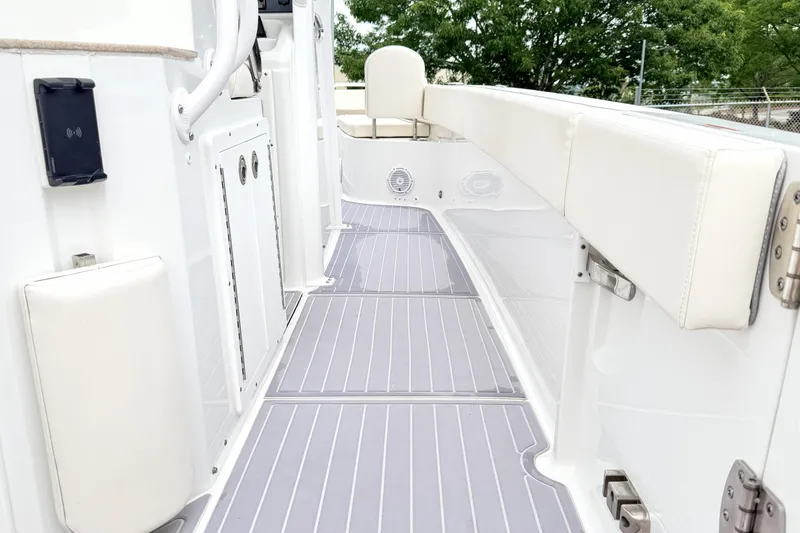Slide: The Image of 2023 Sea Hunt Escape 28 boat interior with sleek white seating and modern design. - 11