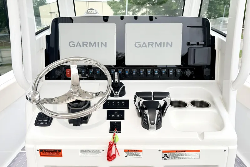 Slide: The Image of Helm of 2023 Sea Hunt Escape 28 with dual Garmin displays and steering wheel. - 13