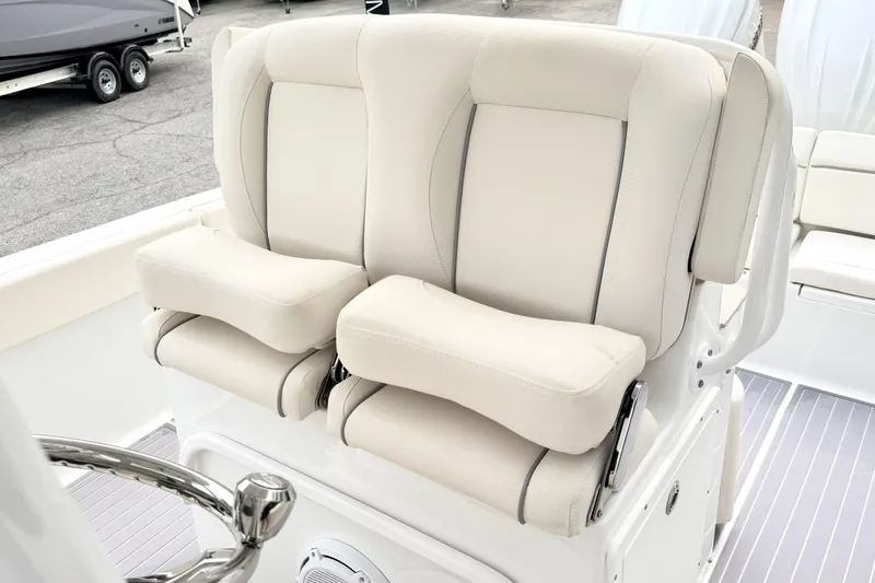 Slide: The Image of 2023 Sea Hunt Escape 28 boat with luxurious dual helm seats in cream upholstery. - 15